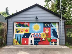 a garage door painted with colorful images on it