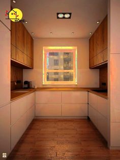 an empty kitchen with wooden floors and white cabinets, lights on the window sill