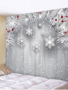 snowflakes are hanging on the wall next to a bed