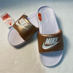 Victori One Slides White With Muted Gold Strap Ynf 13204, 13261 (7) Ynf 12740, 12843 (8) Ynf 12738 (9) Casual Gold Synthetic Slides, Gold Casual Slip-on Slides, Casual Gold Slides For Spring, Casual Brown Slides For Spring, Nike Sporty Slides For Spring, Sporty Brown Slides For Summer, Trendy Synthetic Slides For Sports, White Casual Slides For Spring, Casual White Spring Slides