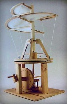 an old fashioned spinning machine with wheels on it's sides and the top part missing