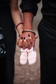 two people holding hands while wearing white gloves