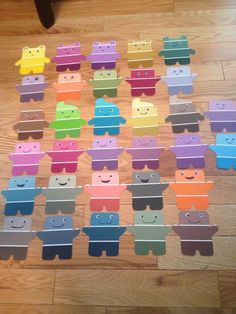 a group of cut out animals sitting on top of a wooden floor