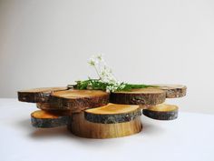 several pieces of wood are stacked on top of each other with flowers in the center