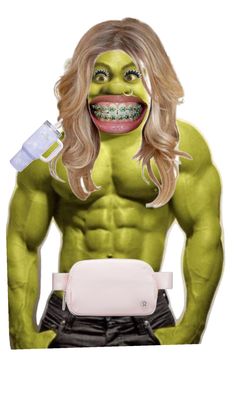 a man with long blonde hair wearing a green mask and holding a toothbrush in his mouth