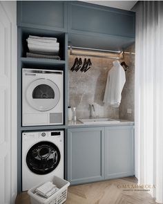 a washer and dryer in a laundry room with blue cabinets on the wall