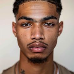 a close up of a person with a necklace on his neck and an unkempt face