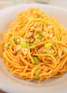 a white plate topped with noodles and vegetables