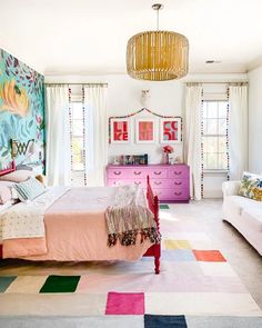 a bedroom with pink furniture and colorful rugs