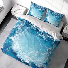 a bed with blue and white waves on it