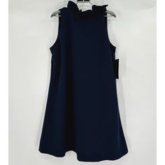 Tuckernuck Women's Blythe Dress Color: Navy Blue Size: Large Retail: $198 Condition: New With Tags Reinforced 2" Ruffle Stand Collar Sleeveless Bow Tie Back Swing Shape Soft Stretch Crepe Fabric Mini Length 97% Polyester, 3% Spandex Machine Wash Cold, Hang To Dry 19.5" Pit-To-Pit 37" Shoulder To Hem Navy Ruffled Dress For Party, Dressy Sleeveless Mini Dress With Ruffles, Navy Party Dress With Ruffles, Ruffled Sleeveless Dress For Workwear, Chic Navy A-line Dress, Blue A-line Sleeveless Dress With Ruffles, Blue Sleeveless A-line Dress With Ruffles, Elegant Navy Sleeveless Mini Dress, Navy Ruffled Mini Dress