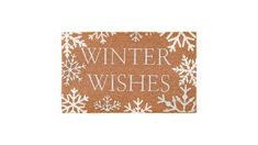 a door mat with the words winter wishes written in white letters on it and snowflakes