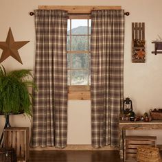 a living room filled with furniture and a star hanging on the wall above a window