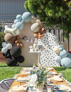 a table set up with balloons and plates