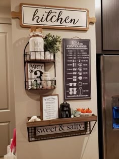 a kitchen with a refrigerator and some signs on the wall