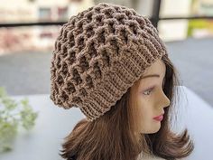 a mannequin head wearing a brown knitted hat