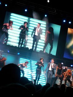 a group of people standing on top of a stage