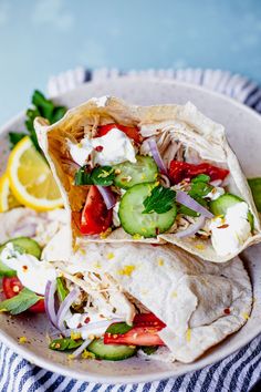 two wraps filled with vegetables on top of a white plate