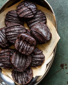 chocolate cookies in a metal bowl on top of a table