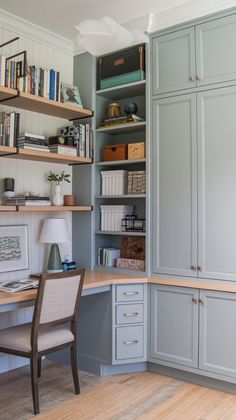 a home office with built in bookshelves and desk