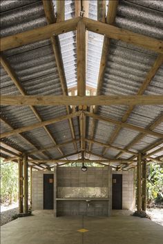 an empty building with wooden beams and concrete walls