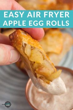 an easy air fryer apple egg rolls is being held up to show the filling