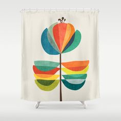 a shower curtain with a colorful flower on it