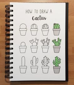 a notebook with drawings of cactuses and cacti in them on a wooden table