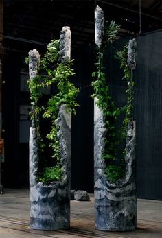 two cement pillars with plants growing out of them