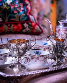 a tray with tea cups and saucers on it