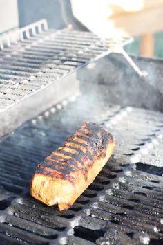 a piece of meat is cooking on the grill