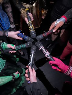 a group of people standing around each other holding microphones