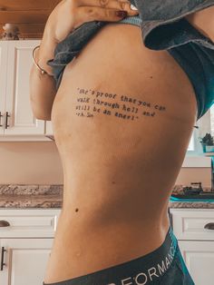 the back of a woman's stomach with words written on her lower body and bottom