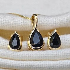 Elegant 9ct Gold solitaire pear dark inky blue/ black sapphire pendant and matching stud earrings. Ojewellery design and part of our first full gold collection. Produced in very small quantities you will only find this set from Ojewellery direct. Set in a raised rub over setting made of 9ct yellow gold to allow light to the back of the stone and show off its natural sparkle. The natural inky blue/ black sapphires are from Australia. The stone measures 7x5 mm in the pendant and 6x4mm in each stud Black Stone Earrings, Black Stud Earrings, Black Stud, Black Sapphire, Sapphire Pendant, Black Pendant, Stone Studs, Gold Collection, Blue Gemstones