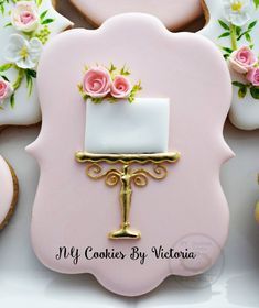 decorated cookies with pink and white frosting on top of each other in the shape of a wedding cake