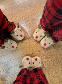 the legs and feet of two people wearing slippers with red nose noses on them