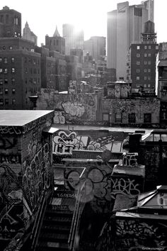 the sun shines brightly on graffiti covered buildings