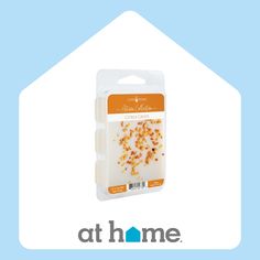 a package of cat food sitting on top of a blue and white house with the logo at home