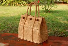 This Tote classic is handwoven in thailand from waterhyacinth and ideal for carrying groceries,and other daily essentials. Measures approximately (DxLxH) 20 x 35 x 30 cm drop length 6.5 inches Cream lining Detail made from ; water hyacinth    HOW TO CARE  1. Avoid humidity and expose them to the sun often. 2. Spot clean with damp cloth SHIPPING: # Processtimes 3-5 days # We will be SHIPPED via THAI AIRMAIL and had TRACKING No. # and Delivery Time 1-5 week We do offer WHOLESALE prices, large quan Rectangular Woven Rattan Bags, Handwoven Rectangular Rattan Bag, Rectangular Rattan Bag For Daily Use, Eco-friendly Rectangular Rattan Bag, Eco-friendly Natural Rattan Bag, Eco-friendly Rectangular Straw Bag With Bamboo Handle, Handwoven Rattan Bag For Daily Use, Eco-friendly Handwoven Rectangular Straw Bag, Eco-friendly Rectangular Handwoven Straw Bag