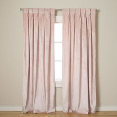 a pink curtain hanging in front of a window