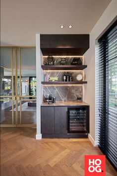 a kitchen with wooden flooring and open shelves