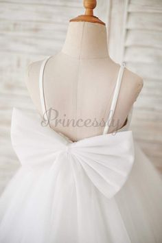 a white dress with a bow on the back