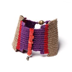 a multicolored knitted bracelet with metal bells on an isolated white background,