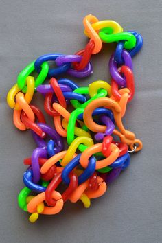 "This listing is for one vintage 1980s plastic rainbow necklace as shown. Add your own vintage charms or wear as is. This is a 24\" long plastic chain link necklace with large chunky links for hanging charms. Bright colorful rainbow colors including neon green and orange links. These are chunkier with wider links than some of the old 80s charm necklaces, shown next to a ruler for scale. Charms with a very small clasp will probably not fit over the links. The fastener will move a little to the si Multicolor Plastic Chain Jewelry, Fun Multicolor Plastic Necklace, Fun Rainbow Plastic Jewelry, Hanging Charms, 80s Jewelry, Hanging Bell, Rainbow Jewelry, Rainbow Necklace, Charm Necklaces