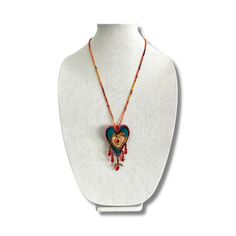 Handmade in Mexico, this so special and colorful accessory features hand embroidered Sagrado Corazon and tiny crystal beads on a silky fabric. Colibri Necklace is 11 inches drop. Ball and joint closure. Traditional Handmade Heart Jewelry, Traditional Handmade Heart-shaped Jewelry, Traditional Multicolor Heart Beads Necklace, Traditional Heart-shaped Jewelry With Heart Beads, Artisan Embroidered Necklaces For Festivals, Traditional Handmade Heart Necklaces, Artisan Multicolor Heart-shaped Jewelry, Multicolor Beaded Heart Pendant Necklace, Multicolor Handmade Heart Beaded Necklaces