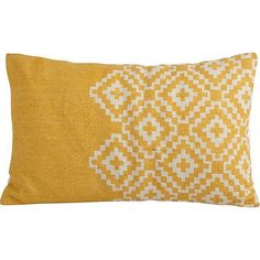 a yellow and white pillow with an intricate design on the front, sitting on a white background