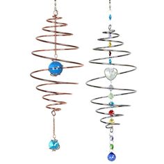 two metal wind chimes hanging from strings with balls and chains attached to each other