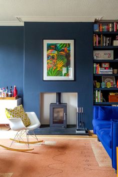 a living room filled with furniture and a fire place next to a bookshelf