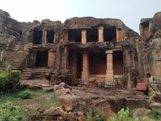 an old building that is surrounded by rocks