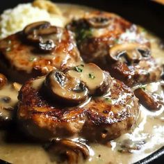 some meat with mushrooms and gravy in a skillet